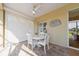 Covered patio dining area features a white table, chairs, and privacy screens at 12140 Whisper Lake Dr, Bradenton, FL 34211