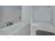 Clean and modern bathroom featuring bright white finishes, a single sink vanity, and a tub-shower combo at 13030 Bayberry Way, Parrish, FL 34219