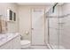Bathroom featuring gray marble countertops, a toilet and a glass enclosed shower at 135 Oakwood Ln, Sarasota, FL 34237