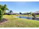 Picturesque backyard with a tranquil pond and well-maintained landscaping at 1365 Western Pine Cir, Sarasota, FL 34240