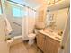 Bright bathroom with a shower-tub combo, vanity, and tiled floors at 1531 Pleasant Rd # H-3, Bradenton, FL 34207