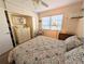 Bright bedroom with a ceiling fan, closet, dresser, and large window at 1531 Pleasant Rd # H-3, Bradenton, FL 34207