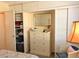 Well-organized closet with shelves and storage solutions, next to a dresser at 1531 Pleasant Rd # H-3, Bradenton, FL 34207