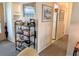 Inviting hallway featuring artwork, bookshelves, and a glimpse into the kitchen at 1531 Pleasant Rd # H-3, Bradenton, FL 34207