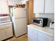 Efficient kitchen layout featuring white appliances, cabinets, and counter space for meal preparation at 1531 Pleasant Rd # H-3, Bradenton, FL 34207