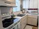 Bright kitchen showcasing appliances, tiled backsplash, and ample countertop space at 1531 Pleasant Rd # H-3, Bradenton, FL 34207