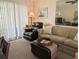Relaxing living room featuring comfortable seating, ample lighting, and access to outdoor living space at 1531 Pleasant Rd # H-3, Bradenton, FL 34207