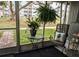 Inviting screened patio with comfortable seating and lovely potted plants for relaxed outdoor living at 1531 Pleasant Rd # H-3, Bradenton, FL 34207