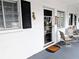 Charming front porch featuring a welcoming entrance, cozy seating area, and sun-shielding window shutters at 1531 Pleasant Rd # H-3, Bradenton, FL 34207