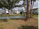 Shuffleboard court is surrounded by benches and lush landscaping at 1531 Pleasant Rd # H-3, Bradenton, FL 34207