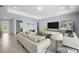 Large living room featuring tile floors, neutral colors, and backyard views at 16039 Dinal Dr, Punta Gorda, FL 33955