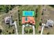 Aerial view showing the location of the tennis court, pool, landscaping, and surrounding properties at 17809 Howling Wolf Run, Parrish, FL 34219