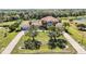 Expansive aerial view of the home with lush landscaping, long driveway, and well-manicured lawn at 17809 Howling Wolf Run, Parrish, FL 34219