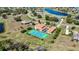 Sprawling estate boasts private tennis court and screened-in pool, complemented by lush landscaping and serene water views at 17809 Howling Wolf Run, Parrish, FL 34219