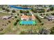 This beautiful property features a private tennis court, screened-in pool, and expansive grounds near a picturesque lake at 17809 Howling Wolf Run, Parrish, FL 34219