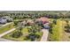 Expansive aerial view of the home with lush landscaping, long driveway, and well-manicured lawn at 17809 Howling Wolf Run, Parrish, FL 34219