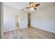 Large bedroom showcases new wood-look floors and ensuite bathroom entrance at 17809 Howling Wolf Run, Parrish, FL 34219