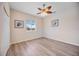 Charming bedroom featuring wood-look floors, artwork, and natural light at 17809 Howling Wolf Run, Parrish, FL 34219