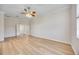 A bright bedroom featuring neutral walls, wood-look floors, and a ceiling fan at 17809 Howling Wolf Run, Parrish, FL 34219