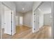A bonus room featuring wood-look vinyl flooring and white doors, with light grey colored walls throughout the room at 17809 Howling Wolf Run, Parrish, FL 34219