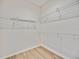 An organized closet with wire shelving and light wood-look flooring at 17809 Howling Wolf Run, Parrish, FL 34219