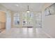 Bright dining area with tile flooring, French doors to patio, and elegant arched windows at 17809 Howling Wolf Run, Parrish, FL 34219