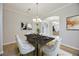Contemporary dining area with stylish table and chairs, modern decor, and wood-look flooring at 17809 Howling Wolf Run, Parrish, FL 34219