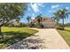 Charming two-story home with brick-paved driveway leading to attached garage, surrounded by lush landscaping at 17809 Howling Wolf Run, Parrish, FL 34219