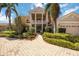 Elegant two-story home featuring manicured landscaping and a welcoming stone pathway to the front door at 17809 Howling Wolf Run, Parrish, FL 34219