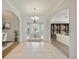 Elegant foyer with tile and wood flooring, featuring arched doorways and a view to the backyard at 17809 Howling Wolf Run, Parrish, FL 34219
