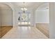 Open-concept foyer with tile and wood flooring and views of the dining area and backyard at 17809 Howling Wolf Run, Parrish, FL 34219