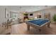 Spacious game room featuring a pool table, living area, wet bar, and access to the outdoor pool at 17809 Howling Wolf Run, Parrish, FL 34219