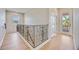 Second floor hallway featuring railing and access to the balcony at 17809 Howling Wolf Run, Parrish, FL 34219