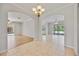 Open living space with tile floors, archways, and views to the pool area at 17809 Howling Wolf Run, Parrish, FL 34219