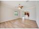 Spacious living room with hardwood flooring and lots of natural light from large windows at 17809 Howling Wolf Run, Parrish, FL 34219