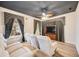 Cozy media room with tiered seating, a large television, and dramatic blackout curtains at 17809 Howling Wolf Run, Parrish, FL 34219