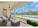 A furnished outdoor patio featuring ceiling fan, string lights and a beautiful view of the community tennis court at 17809 Howling Wolf Run, Parrish, FL 34219