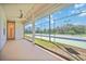 Covered outdoor patio featuring a ceiling fan, string lights and a view of the community tennis court at 17809 Howling Wolf Run, Parrish, FL 34219