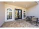 Cozy patio with tile flooring, arched windows, and an outdoor dining set for relaxing at 17809 Howling Wolf Run, Parrish, FL 34219