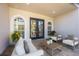 Cozy patio with tile flooring, arched windows, and an outdoor seating area with plush cushions at 17809 Howling Wolf Run, Parrish, FL 34219