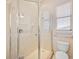 Bathroom features a glass enclosed shower with tile surround and chrome fixtures at 17809 Howling Wolf Run, Parrish, FL 34219