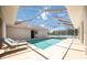 A beautiful swimming pool, enclosed in a screened enclosure with lounge chairs and a tennis court nearby at 17809 Howling Wolf Run, Parrish, FL 34219