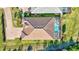 Aerial view of home's roof and screened in pool with view of the yard and surrounding landscaping at 18115 Littleton Pl, Bradenton, FL 34202