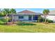 Relaxing backyard featuring a screened-in lanai, lush landscaping, and a pool and spa, ideal for outdoor living at 18115 Littleton Pl, Bradenton, FL 34202