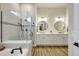 Luxurious bathroom with a glass-enclosed shower, soaking tub, and double vanities at 18115 Littleton Pl, Bradenton, FL 34202