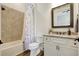 Bathroom featuring a shower/tub combo, granite vanity, and white shaker cabinets at 18115 Littleton Pl, Bradenton, FL 34202