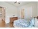 Neutral guest bedroom with wood-look floors, ensuite bathroom access, and woven dresser at 18115 Littleton Pl, Bradenton, FL 34202