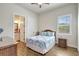 Guest bedroom with bright natural light, wood-look floors, and ensuite bathroom access at 18115 Littleton Pl, Bradenton, FL 34202