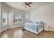 Bright bedroom with wood-look tile flooring and large windows offering natural light at 18115 Littleton Pl, Bradenton, FL 34202