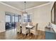 Elegant dining room featuring a modern light fixture, with a view of an outdoor seating area at 18115 Littleton Pl, Bradenton, FL 34202